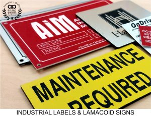 Collection of Industrial Nameplates,, Lamacoid Signs and Labels - Black and Yellow Safety Label, Red and White Warning Label, White and Black Nameplate, and Silver Door Sign with Black Engraving for the City of Hamilton, Ontario.